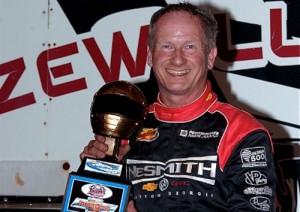 Ronnie Johnson of Chattanooga, TN hoists his second Gold Helmet Trophy of the 2014 season after winning the 50-lap Chevrolet Performance Super Late Model Series main event on Saturday night at Tazewell Speedway. Photo by Brian McLeod