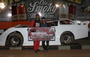 Adam Beeler of Knoxville, TN (right) remains a NeSmith Chevrolet Weekly Racing Series $10,000 title contender after picking up his third win of the season on Saturday night at 411 Motor Speedway in Seymour, TN in the Jack Henderson Memorial Race.  The late Jack Henderson’s son Matt Henderson (left) presents Beeler with the $1,000 Winner’s check.  Photo by Chad Wells