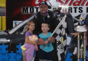 Curt Britt celebrates with family in victory lane after winning the Pro Truck feature.  Photo by Terry Spackman