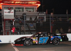 Justin Carroll sweeps under the checkered flag to score the Late Model Stock victory in the first of two features Saturday night at Ace Speedway.  Photo courtesy Moonshine Capital Promotions