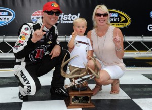 Kevin Harvick poses with his wife DeLana and son Keelan after scoring the pole award in qualifying for Saturday night's NASCAR Sprint Cup Series race at Bristol Motor Speedway.  Photo by Rainier Ehrhardt/Getty Images