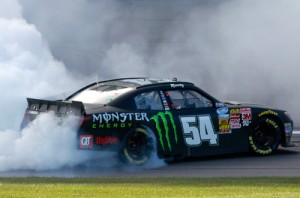 Kyle Busch celebrates with a burnout after winning Saturday's NASCAR Nationwide Series race at  Kansas Speedway.  Photo by Brian Lawdermilk/NASCAR via Getty Images