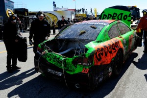 Danica Patrick's damaged car is towed through the garage area after an incident during practice Wednesday at Daytona International Speedway.  Photo by Jared C. Tilton/Getty Images for NASCAR