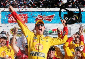 Joey Logano celebrates in victory lane after winning Sunday's Daytona 500 on a green-white-checkered finish Sunday afternoon.  Photo by Chris Graythen/Getty Images