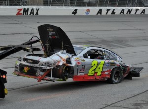 Jeff Gordon's demolished car is towed back to the garage area after he was caught up in a lap 258 crash.  Photo by David Weikel