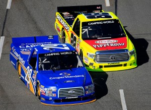 Joey Logano (29) battles with Matt Crafton (88) during Saturday's NASCAR Camping World Truck Series race at Martinsville Speedway.  Logano would score the victory with an overtime pass on Crafton for the lead.  Photo by Rob Carr/Getty Images