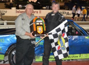 Steve Buttrick poses in victory lane after scoring the jukebox trophy for winning Saturday night's Sportsman feature at Mobile International Speedway.  Photo courtesy MIS Media
