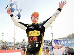 Alex Tagliani waves to the crowd from victory land after winning Saturday's NASCAR Canadian Tire Series race at Sunset Speedway.  Photo by Matthew Manor/Getty Images for NASCAR