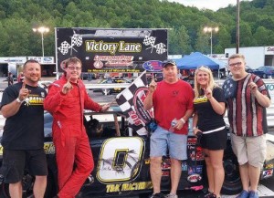 Kyle Barnes celebrates with his team after winning the first of two Late Model Stock features Saturday at Lonesome Pine Raceway.  Photo by Chase Brashears