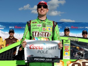 Kyle Busch poses with the Coors Light Pole Award after qualifying for the pole for Sunday's NASCAR Sprint Cup Series race at Pocono Raceway.  Photo by Tim Bradbury/Getty Images
