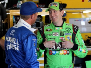 Kyle Busch (right) and Clint Bowyer (left) talk in the garage during practice for Sunday's NASCAR Sprint Cup Series race at Pocono Raceway.  Photo by Tim Bradbury/Getty Images