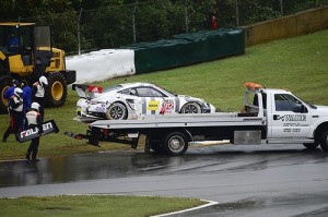 Earl Bamber's Porsche is loaded onto a flatbed and taken back to the pits following a crash during GTLM qualifying. Photo by Richard Dole LAT Photo USA