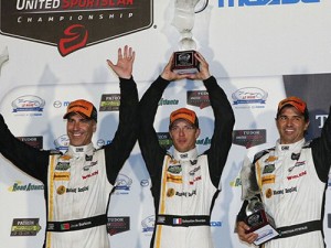 Joao Barbosa, Sebastien Bourdais and Christian Fittipaldi celebrate after scoring the Prototype division win at Road Atlanta in the Petit Le Mans Saturday night, along with their second TUDOR United SportsCar Championship.  Photo by Michael L. Levitt LAT Photo USA
