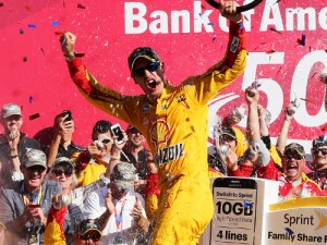 Joey Logano celebrates in victory lane after winning Sunday's NASCAR Sprint Cup Series race at Charlotte Motor Speedway.  Photo by Jerry Markland/Getty Images