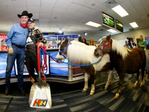Texas Motor Speedway President Eddie Gossage (left) presents retiring driver Jeff Gordon with Shetland ponies for his kids during a press conference Friday at Texas Motor Speedway. Photo by Tom Pennington/Getty Images