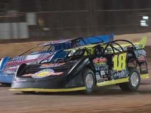 Chase Edge (18) drives under Ryan Carter (52) to take the lead on the third lap of Friday night's NeSmith Chevrolet Dirt Late Model Series RockAuto.com Winter Shootout race at Golden Isles Speedway.  Photo by Bruce Carroll/NeSmith Media