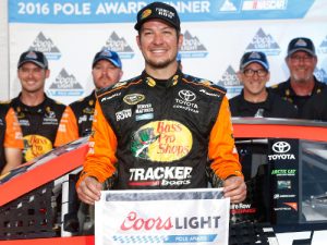 Martin Truex, Jr. poses with the Coors Light Pole Award after qualifying for the pole position for Sunday's NASCAR Sprint Cup Series race at Charlotte Motor Speedway.  Photo by Brian Lawdermilk/Getty Images
