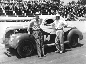 Car owner Raymond Parks (left) and his driver Bob Flock (right) before the start of a Modified Stock Car race in 1956 at Greenville-Pickens Speedway.  Photo: ISC Archives via Getty Images
