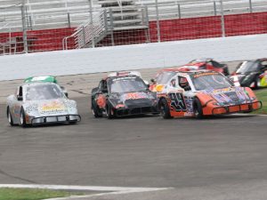 Clay Thompson (99) makes the pass on Joshua Kossek (44) and Nathan Jackson (7) en route to the victory in Wednesday's Bandolero Bandits victory at Atlanta Motor Speedway. Photo by Tom Francisco/Speedpics.net