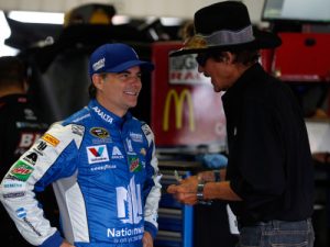 Jeff Gordon, and NASCAR Hall of Fame driver Richard Petty talk in the garage area during Friday's practice for Sunday's NASCAR Sprint Cup Series race at Pocono Raceway.  Photo by Brian Lawdermilk/Getty Images