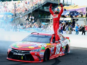 Kyle Busch waves to the crowd after winning Sunday's NASCAR Sprint Cup Series race at the Indianapolis Motor Speedway. Photo by Robert Laberge/Getty Images