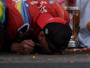 Kyle Busch kisses the bricks at the start/finish line after winning Sunday's NASCAR Sprint Cup Series race at the Indianapolis Motor Speedway. Photo by Bobby Ellis/Getty Images