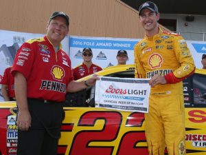 Joey Logano (right) and crew chief Todd Gordon (left) pose with the Coors Light Pole Award after Logano scored the pole position in qualifying for Sunday's NASCAR Sprint Cup Series race at Michigan International Speedway.  Photo by Sean Gardner/Getty Images