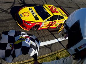 Joey Logano takes the checkered flag to win last year's NASCAR Sprint Cup Series race at Watkins Glen International. Photo by Jared C. Tilton/Getty Images