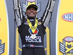 Antron Brown celebrates after scoring the Top Fuel victory on Sunday at zMax Dragway near Charlotte, North Carolina.  Photo: NHRA Media