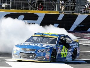 Jimmie Johnson celebrates with a burnout after winning Sunday's rain delayed NASCAR Sprint Cup Series race at Charlotte Motor Speedway.  Photo by Jerry Markland/NASCAR via Getty Images