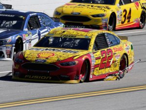Joey Logano takes a lap with the jack wedged under his car after a pit stop. He would return to the pits the next lap to remove the equipment. Photo: NASCAR Media
