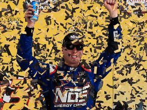 Kyle Busch celebrates in victory lane after winning Saturday's NASCAR Xfinity Series race at Kansas Speedway.  Photo by Chris Trotman/Getty Images