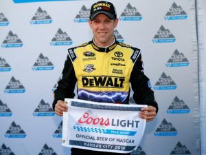 Matt Kenseth poses with the Coors Light Pole Award after qualifying in the pole position for Sunday's NASCAR Sprint Cup Series race at Kansas Speedway.  Photo by Matt Sullivan/Getty Images