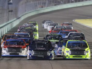 Timothy Peters (17), William Byron (9) and Matt Crafton (88) lead the field during Friday night's NASCAR Camping World Truck Series race at Homestead-Miami Speedway.  Photo by Sean Gardner/NASCAR via Getty Images