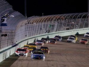 Jimmie Johnson takes the checkered flag to win Sunday night's NASCAR Sprint Cup Series race at Homestead-Miami Speedway. Photo by Chris Trotman/Getty Images