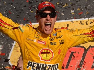 Joey Logano celebrates after winning Sunday's NASCAR Sprint Cup Series race at Phoenix International Raceway, moving him to next week's championship round at Homestead. Photo by Robert Laberge/NASCAR via Getty Images