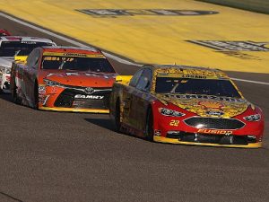 Joey Logano (22) and Carl Edwards (19) get ready for a restart during Sunday night's NASCAR Sprint Cup Series race at Homestead-Miami Speedway. Photo by Sean Gardner/NASCAR via Getty Images