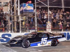 Christian Eckes (15) edges out John Hunter Nemechek (8) at the checkered flag to win the rain delayed Snowball Derby at 5 Flags Speedway.  Photo by Eddie Richie/Turn One Photos/Loxley, AL