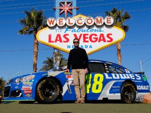 NASCAR Sprint Cup Series champion Jimmie Johnson poses in front of the Welcome to Las Vegas sign during NASCAR Champion's Week on Wednesday.  Photo by Jonathan Ferrey/NASCAR via Getty Images